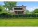 Backyard view of the house featuring a screened in porch and a well-maintained lawn surrounded by lush greenery at 9060 Par Dr, Douglasville, GA 30134
