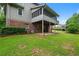 Exterior view of a home with a screened porch, a patio and well-kept lawn for leisure outdoor activities at 9060 Par Dr, Douglasville, GA 30134
