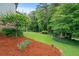 Expansive backyard with mature trees, lush landscaping, and a serene setting, ideal for relaxation at 9060 Par Dr, Douglasville, GA 30134