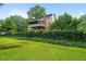 A spacious backyard with lush green grass and a row of bushes. Perfect area for relaxing or entertaining guests at 9060 Par Dr, Douglasville, GA 30134
