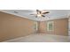 Bedroom with neutral colored walls, carpet flooring, base molding, and a large window at 9060 Par Dr, Douglasville, GA 30134