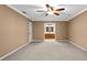Spacious main bedroom with ensuite bathroom and a ceiling fan and light at 9060 Par Dr, Douglasville, GA 30134
