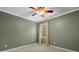 Bedroom with neutral colored walls, carpet flooring, base molding, and a large window at 9060 Par Dr, Douglasville, GA 30134