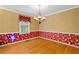 Elegant dining room with hardwood floors, decorative wallpaper, and a chandelier, perfect for hosting dinner parties at 9060 Par Dr, Douglasville, GA 30134