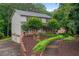 Two-story home with a well-manicured lawn, mature trees, and a charming front porch at 9060 Par Dr, Douglasville, GA 30134