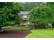 Charming home surrounded by mature trees and lush greenery, showcasing a well-maintained landscape at 9060 Par Dr, Douglasville, GA 30134