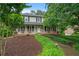 Charming two-story home with a welcoming front porch, well-maintained landscaping, and a classic facade at 9060 Par Dr, Douglasville, GA 30134