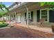 Spacious front porch with brick accents, rocking chairs, and classic columns, perfect for relaxing outdoors at 9060 Par Dr, Douglasville, GA 30134