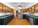 Traditional kitchen features wooden cabinetry, stainless steel appliances, green countertops, and hardwood floors at 9060 Par Dr, Douglasville, GA 30134