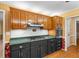 Traditional kitchen featuring wooden cabinetry, stainless steel appliances, green countertops, and hardwood floors at 9060 Par Dr, Douglasville, GA 30134