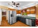 Traditional kitchen features wooden cabinetry, stainless steel appliances, green countertops, and hardwood floors at 9060 Par Dr, Douglasville, GA 30134