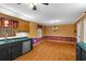 Eat-in kitchen featuring dark cabinetry, green countertops, stainless steel appliances, and hardwood floors at 9060 Par Dr, Douglasville, GA 30134