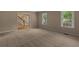 Open living room featuring neutral walls, carpet and multiple windows with blinds at 9060 Par Dr, Douglasville, GA 30134