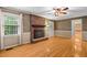 Spacious living room features hardwood floors, fireplace with brick surround, and a bright window at 9060 Par Dr, Douglasville, GA 30134
