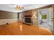 Living room features hardwood floors, fireplace with brick surround, neutral paint, and access to an enclosed patio at 9060 Par Dr, Douglasville, GA 30134