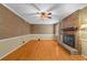 Spacious living room features hardwood floors, fireplace with brick surround, and neutral walls at 9060 Par Dr, Douglasville, GA 30134