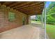 Spacious outdoor patio with brick flooring and exposed wood ceiling, perfect for entertaining or relaxing outdoors at 9060 Par Dr, Douglasville, GA 30134