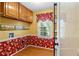 Room with hardwood floors, neutral walls, bright window, laundry connections, and access to the backyard at 9060 Par Dr, Douglasville, GA 30134