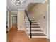 Classic staircase with wooden steps and white spindles leading to the upper level, open floor plan and hardwood floors at 9060 Par Dr, Douglasville, GA 30134
