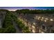Aerial community view of townhomes with street parking, mature trees, sidewalks and outdoor lighting at sunset at 1120 Cordia Nw Ave, Atlanta, GA 30318