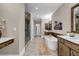 Elegant bathroom featuring a soaking tub, glass shower, and dual vanities with wood accents at 1120 Cordia Nw Ave, Atlanta, GA 30318