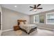 Bedroom features a wood headboard, ceiling fan, and natural light from windows at 1120 Cordia Nw Ave, Atlanta, GA 30318