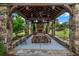 Picturesque community pavilion featuring a stone fireplace, ceiling fan, hanging lamps, and wooden furniture for outdoor enjoyment at 1120 Cordia Nw Ave, Atlanta, GA 30318