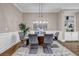 Beautiful dining room with seating for six, featuring a modern chandelier and built-in shelving at 1120 Cordia Nw Ave, Atlanta, GA 30318