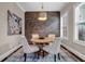 Cozy dining room features a round table, brick accent wall, and stylish light fixture at 1120 Cordia Nw Ave, Atlanta, GA 30318