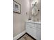 Modern half bathroom with white vanity, marble countertop, and stylish mirror at 1120 Cordia Nw Ave, Atlanta, GA 30318