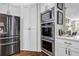Modern kitchen featuring stainless steel appliances, double ovens and ample white cabinets at 1120 Cordia Nw Ave, Atlanta, GA 30318