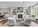 Bright living room with fireplace, built-in shelving, and four comfortable white swivel chairs at 1120 Cordia Nw Ave, Atlanta, GA 30318