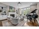 Elegant living room featuring built-in bookshelves, a fireplace, large windows and a grand piano at 1120 Cordia Nw Ave, Atlanta, GA 30318