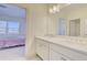 Bright bathroom featuring a double vanity with stone countertop and white cabinets at 3173 Rockbridge Rd, Avondale Estates, GA 30002