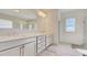 Bright bathroom with double sinks, white cabinets and a large mirror and shower in background at 3173 Rockbridge Rd, Avondale Estates, GA 30002