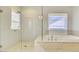 Bright bathroom featuring a large glass shower and soaking tub at 3173 Rockbridge Rd, Avondale Estates, GA 30002