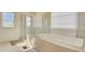 Modern bathroom showcasing a shower with a glass door and a soaking tub at 3173 Rockbridge Rd, Avondale Estates, GA 30002