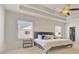 Bright bedroom featuring a tray ceiling, ceiling fan and a glimpse into a large closet at 3173 Rockbridge Rd, Avondale Estates, GA 30002