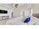 Spacious bedroom with a large TV, neutral walls, tray ceiling and a ceiling fan at 3173 Rockbridge Rd, Avondale Estates, GA 30002