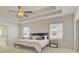 A bedroom with tray ceilings, ceiling fan, light walls and light-colored carpet at 3173 Rockbridge Rd, Avondale Estates, GA 30002