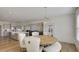 Open-concept dining area features a round wooden table, elegant chairs, and a modern chandelier at 3173 Rockbridge Rd, Avondale Estates, GA 30002
