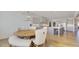 Open dining area with modern light fixture overlooking the kitchen with grey cabinets and hardwood floors at 3173 Rockbridge Rd, Avondale Estates, GA 30002