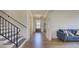 Inviting entryway features hardwood floors, staircase with iron railing, and stylish furnishings at 3173 Rockbridge Rd, Avondale Estates, GA 30002