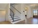 Elegant entryway with hardwood floors, staircase with iron railing, and front door with glass at 3173 Rockbridge Rd, Avondale Estates, GA 30002