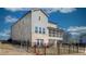 Rear view of a two-story home with black fencing and a combination of vinyl and brick at 3173 Rockbridge Rd, Avondale Estates, GA 30002