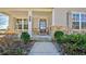 Welcoming front porch with stone accents, elegant columns, and attractive landscaping enhance this home at 3173 Rockbridge Rd, Avondale Estates, GA 30002