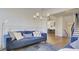 Cozy living room with hardwood floors, modern lighting, comfortable sofa, and view of stairs at 3173 Rockbridge Rd, Avondale Estates, GA 30002