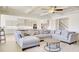 Spacious living room with a plush grey sectional, modern ceiling fan, and open access to the kitchen at 3173 Rockbridge Rd, Avondale Estates, GA 30002