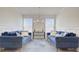Bright living room with twin couches, decorative pillows, modern lighting, and natural light from windows at 3173 Rockbridge Rd, Avondale Estates, GA 30002