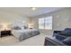 Serene main bedroom with large bed, accent chairs, and plenty of natural light from the window at 3173 Rockbridge Rd, Avondale Estates, GA 30002